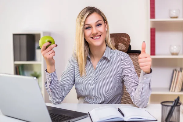 Empresaria Comiendo Manzana Mostrando Pulgar Hacia Arriba Mientras Trabaja Oficina —  Fotos de Stock