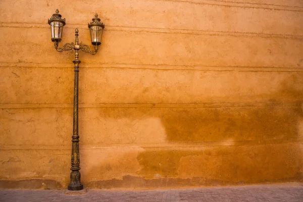 Image of old wall and street lamp in Morocco.