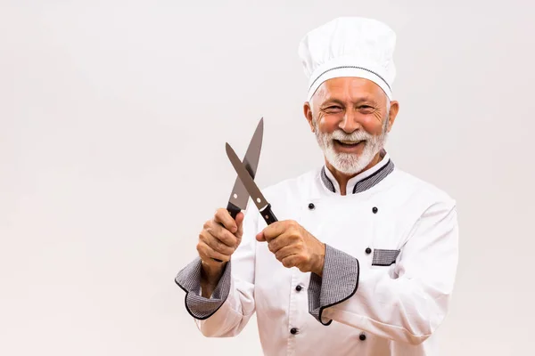快乐厨师在灰色背景下磨刀的图像 — 图库照片
