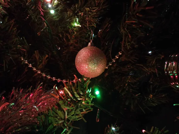 Christmas tree ornaments with globes, installation and tinsel