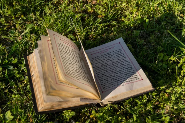 Closeup of prayer book in green grass