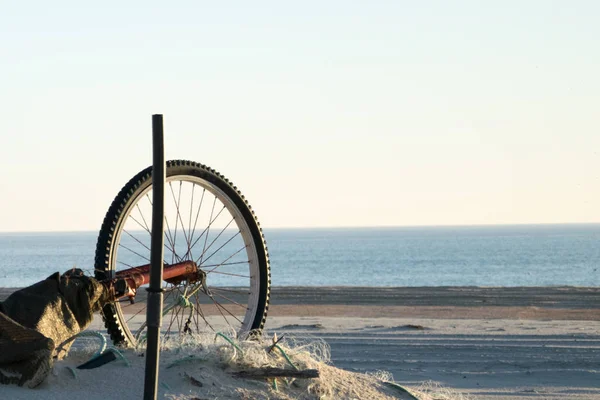 Abandoned bike on beach.