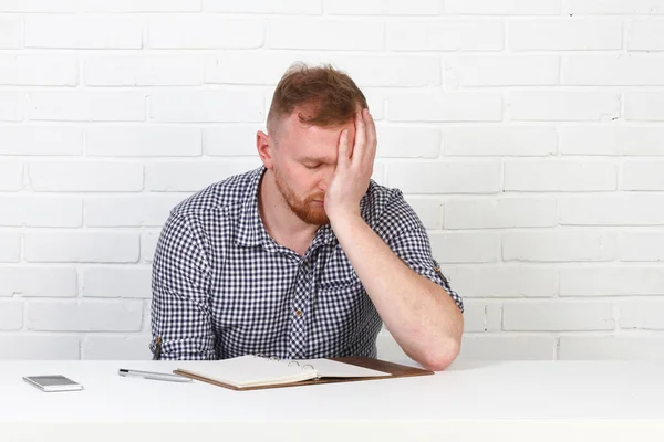 Confident businessman reading a contract. Businessman reading a contract in an Office behind a desk. Isolated. Emotions.