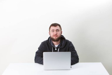 Programcı dizüstü çalışır. İzole, beyaz bir arka plan üzerinde bir kişi. Sakin.