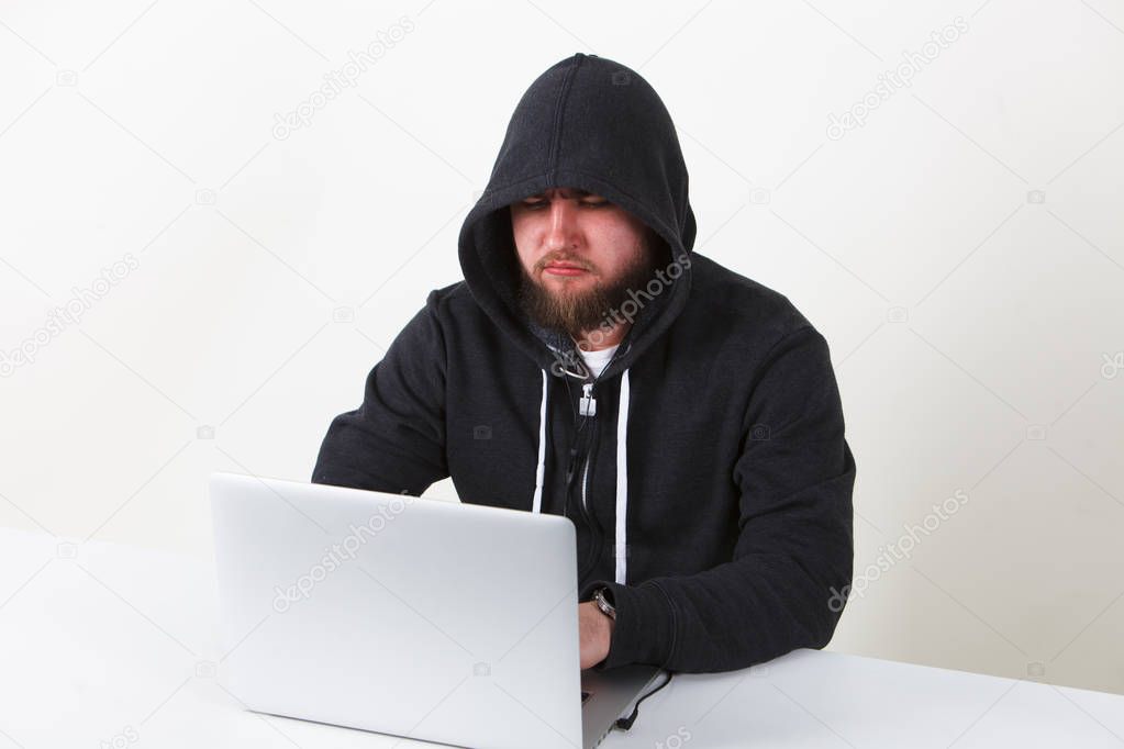 The programmer works behind the laptop. Isolated, one person on a white background.