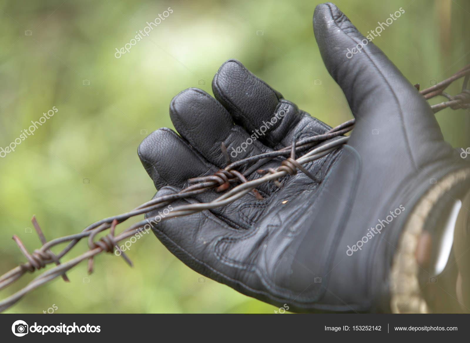 Hand in military glove and barbed wire — Stock Photo © vcvadim #153252142