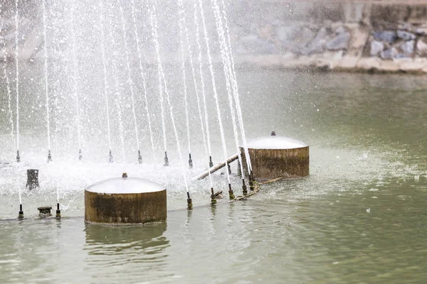 Fountain nozzle sprinkler spray head in pond with buoy