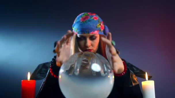 Feiticeira fêmea se perguntando sobre bola de cristal mágico e olhando com assustador . — Vídeo de Stock