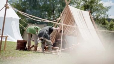 Monterano 'daki ortaçağ köyü, kırsal köylüler çadırı kurmuş ve ateş yakmak için odun hazırlıyorlardı. Yemek pişirmek için yanan kamp ateşi, köy halkı yaşam tarzı.
