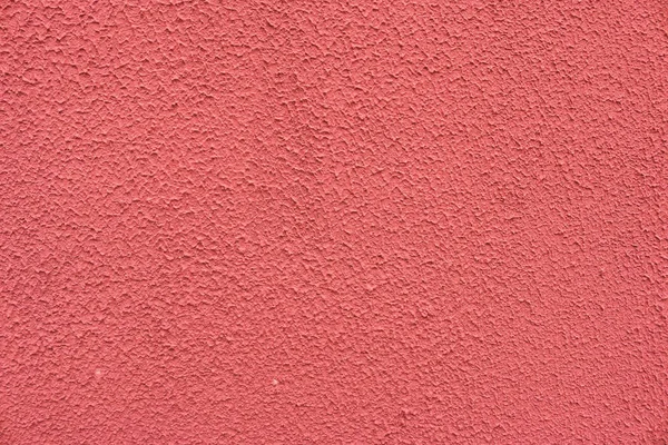 pink decorative plaster on the facade of the building
