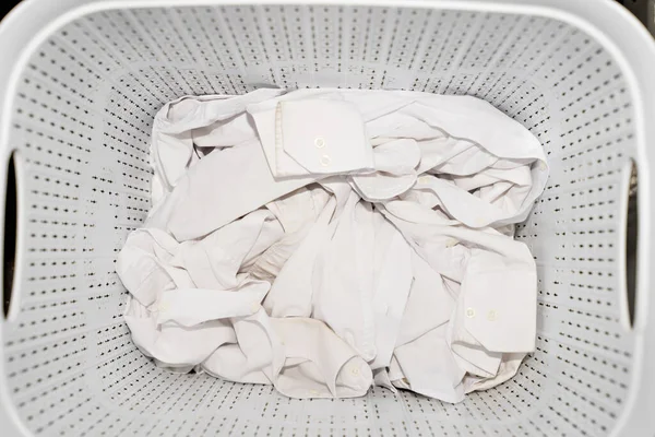 Βρώμικο κλείσιμο και mens λευκά πουκάμισα στο καλάθι πλυντηρίων — Φωτογραφία Αρχείου