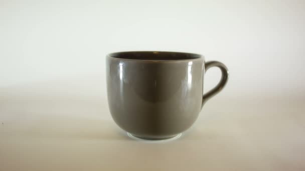verser des grains de café dans une grande tasse de café 