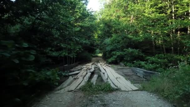 Traverser le pont en bois sur la rivière dans le caucase — Video