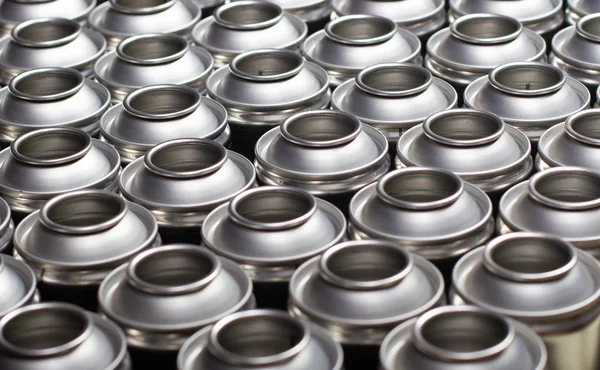 A large number of aerosol cans on a black background. — Stock Photo, Image