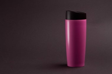 one pink thermal bottle shaker for sports nutrition on a black b