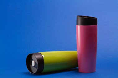 two multi-colored thermal shaker bottles for sports nutrition on