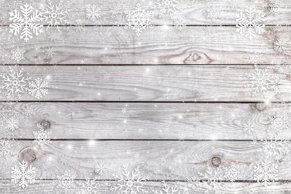 Copos de nieve sobre un fondo de madera . — Foto de Stock