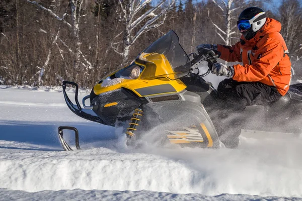 Athlete on a snowmobile — Stock Photo, Image