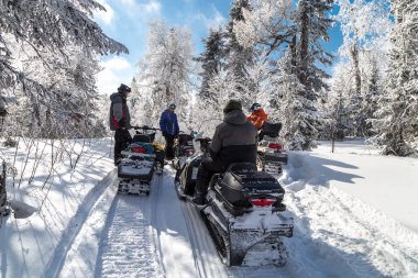 Athletes on a snowmobile clipart