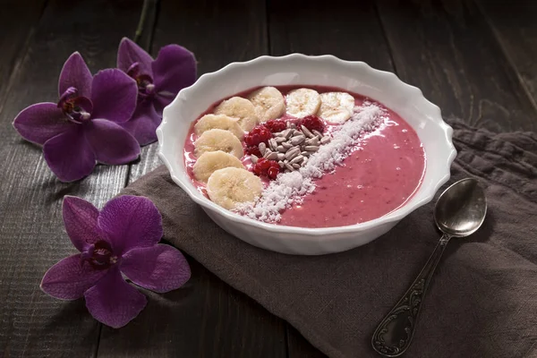 Apple-currant smoothie Bowl with bananas, raspberries, coconut and seeds. Healthy breakfast.