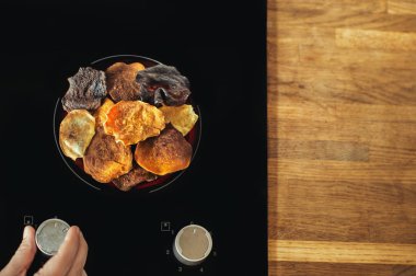 Sebze cips bir elektrikli soba ve aşçı yalan. Sebze ve patates cipsi hazırlanması