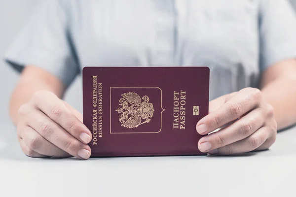 Immigration and passport control at the airport. woman border control officer puts a stamp in the Russian passport. Concept