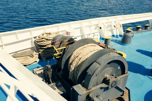 A big sheave with coiled hawser on the open deck of the ferryboat. Ferry summer cruise in Greece