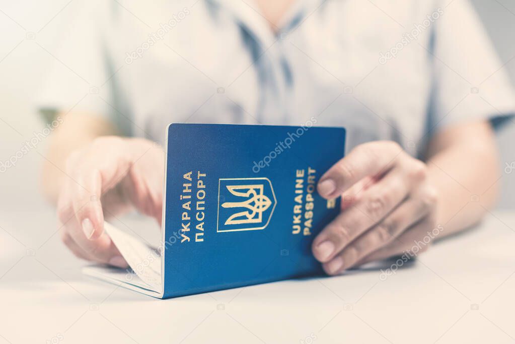 Immigration and passport control at the airport. woman border control officer with Ukrainian passport. Concept