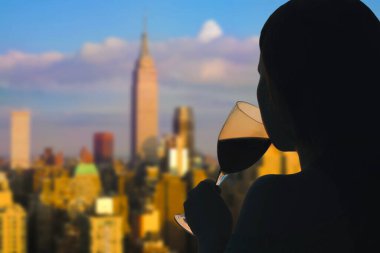 Chicago 'nun arka planında, Illinois, Usa' da bir bardak şarap içen bir kadın. Restoranın çatısında servis var.