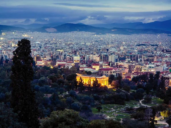 View of illumination Athens city with Lycabettus hill in the background. Plaka neighborhood. Night scene