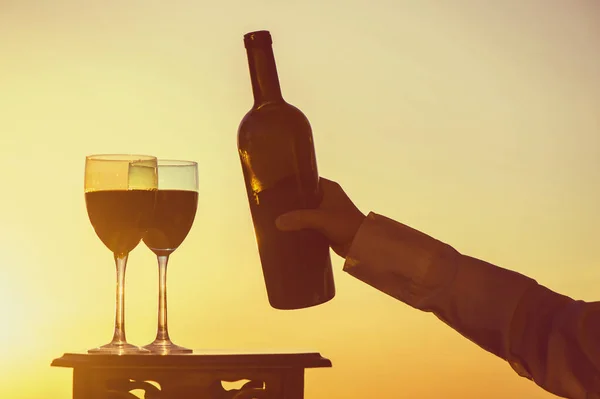 Mão Feminina Com Garrafa Vinho Dois Copos Fundo Pôr Sol — Fotografia de Stock