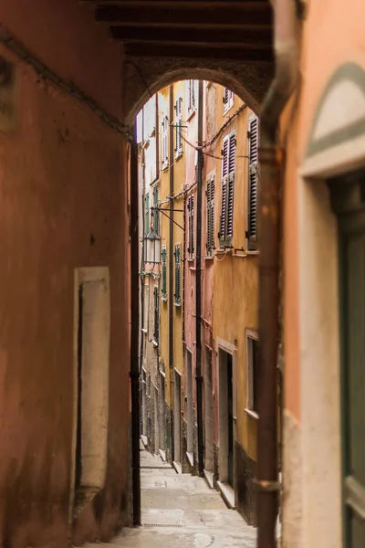 narrow street with colorful buildings in small colorful village Lerici in liguria, italy