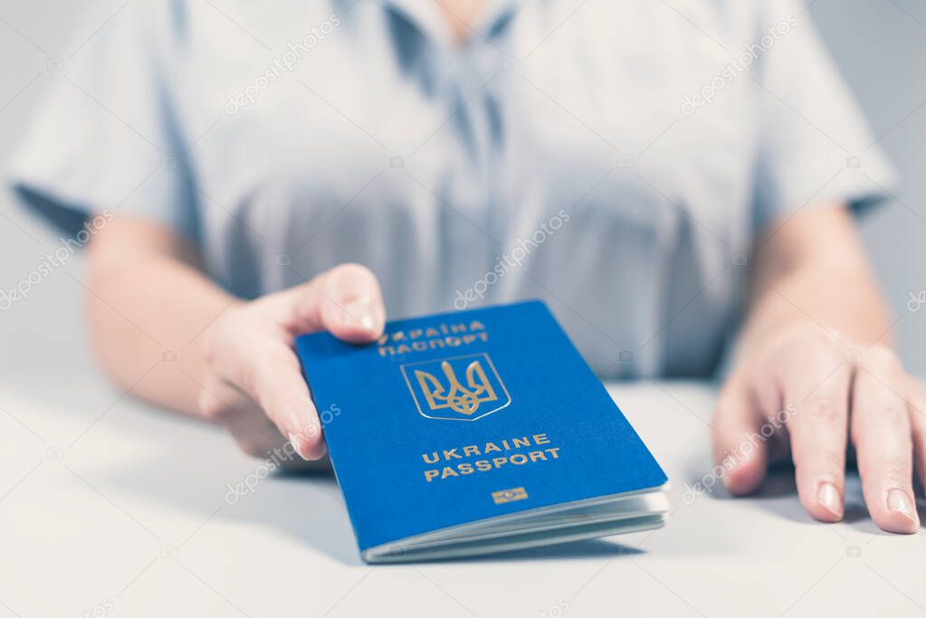 Immigration and passport control at the airport. woman border control officer with Ukrainian passport. Concept