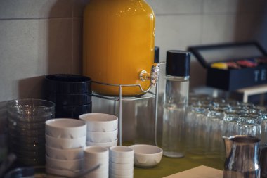 Fresh and bright continental breakfast table with juce and cups. Table settings