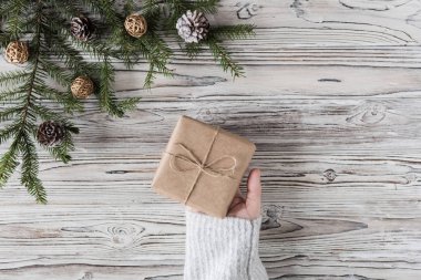 Kadın hediye paketi. Kağıt üzerinde mukavva kutu, Noel ipi ve ahşap arka planda ağaç. Diy..