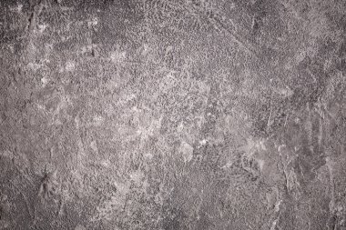 Eski siyah ve gri beton bir duvarın dokusu ve arka planı. Çimento