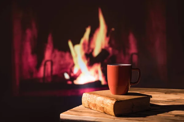 Book Cup Hot Drink Wood Table Christmas Fireplace Cozy Atmosphere — 스톡 사진