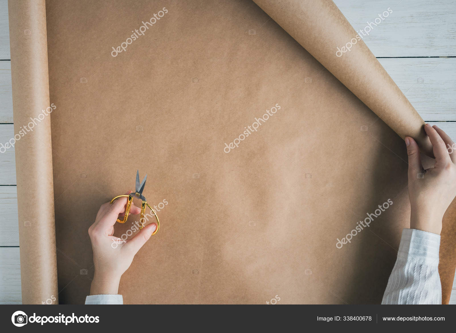 Hands of Caucasian woman wrapping bouquet in brown paper Stock