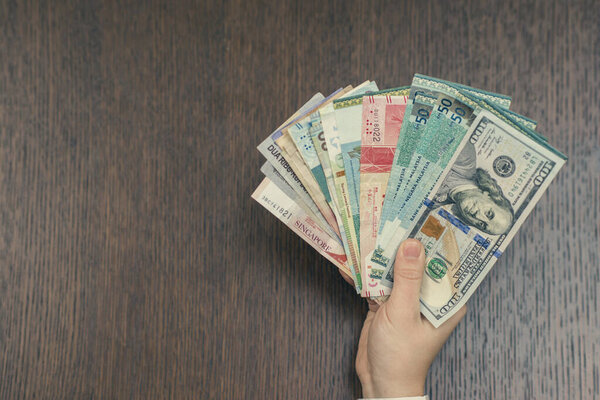 woman holding various money bills
