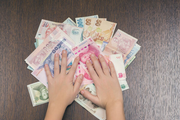 woman holding various money bills
