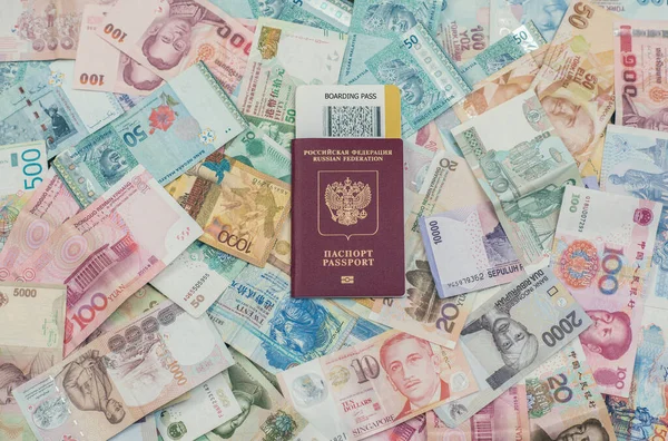 passport with ticket over money, travel and vacation concept
