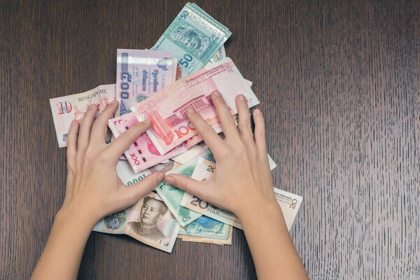 woman holding various money bills