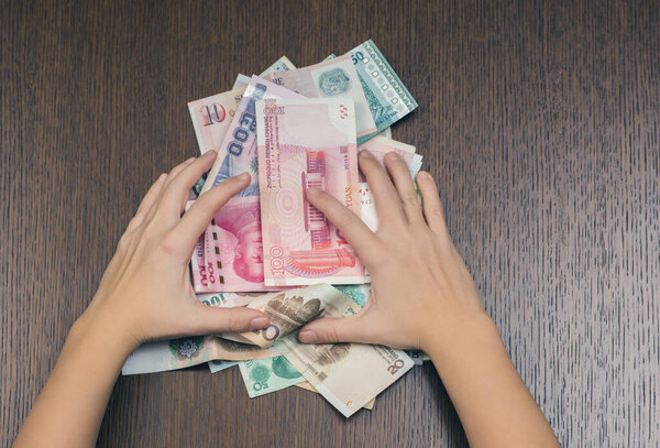 woman holding various money bills