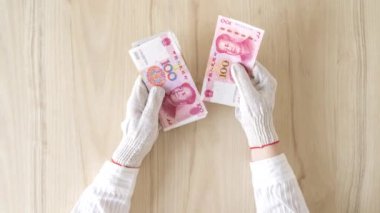 Koronavirüs (virüs) eldivenlerinden korunan Çinli kadınlar Güneydoğu Asya 'dan para sayıyorlar. Çin Yuanı (Cny) Hong Kong, Endonezya, Malezya, Tayland, Singapur doları.