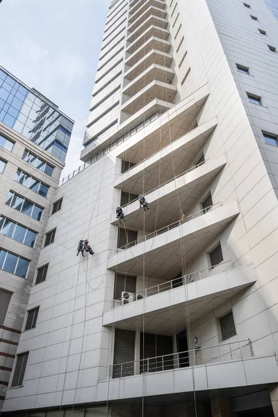 High rise windows and buildings cleaner. Street building disinfection and sanitization due to the emergence of coronavirus or Covid-19.