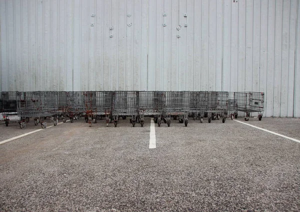 Industrial Iron Trolleys at Parking  Lot with White Stripes — Stock Photo, Image