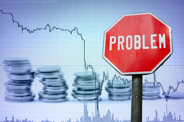 Problem sign on economy background - graph and coins. Financial crash in world economy because of coronavirus. Global economic crisis, recession.