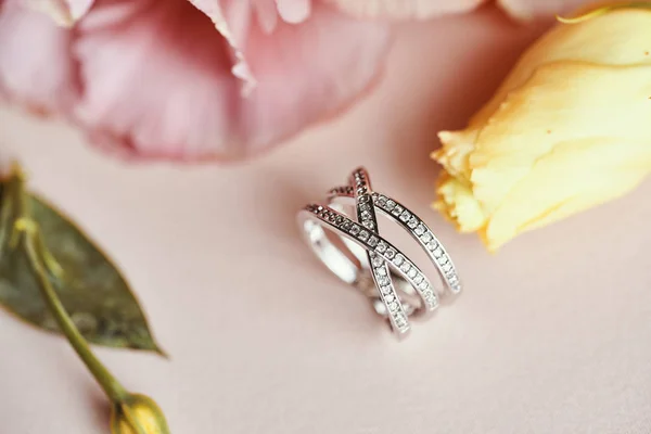 Diamond Ring and Pink Flower Background