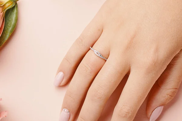 Ring on woman finger.