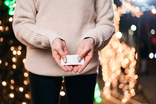 Hand warmers on night lights background.